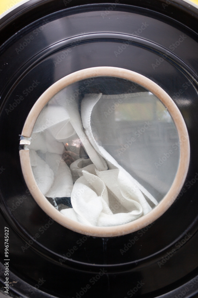 Close shot on washing laundry in big launderette no face Close shot on washing laundry in big launderette no face