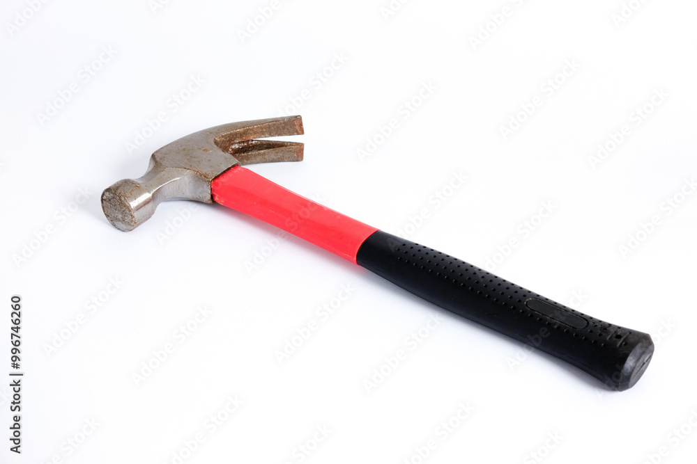 Close up medium sized hammer that has two functions as a nail pick and nail hammer, with a handle covered in black and red rubber isolated on a white background. Little bit rusty Close up medium sized hammer that has two functions as a nail pick and nail hammer, with a handle covered in black and red rubber isolated on a white background. Little bit rusty