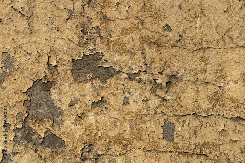 Layers of peeling paint and cracks showcase the rich history and texture of a weathered wall in a forgotten space. Layers of peeling paint and cracks showcase the rich history and texture of a weathered wall in a forgotten space.
