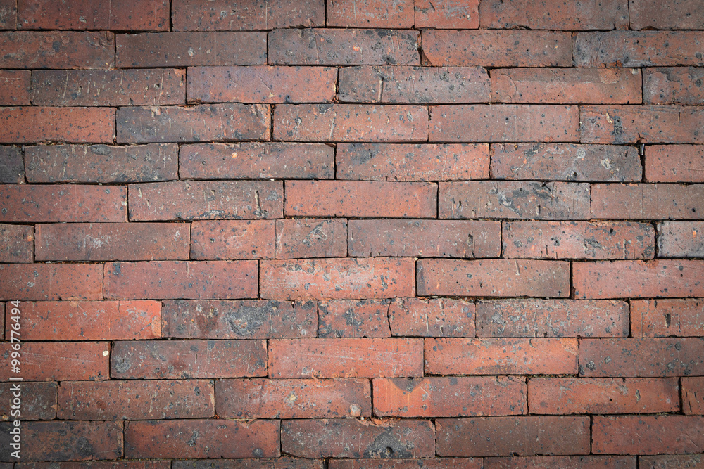 Fototapeta premium This backdrop features a rustic arrangement of worn bricks, showcasing unique textures and earthy tones.