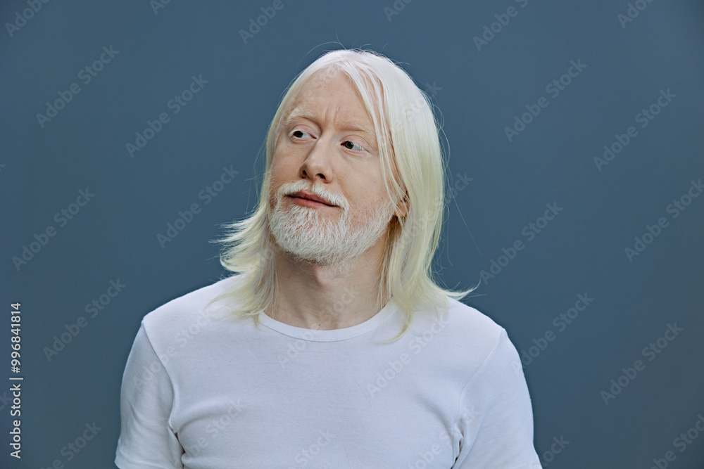 Portrait of a mature man with long white hair and a beard, wearing a plain white t shirt, against a soft blue background, conveying calmness and wisdom, ideal for lifestyle imagery Portrait of a mature man with long white hair and a beard, wearing a plain white t shirt, against a soft blue background, conveying calmness and wisdom, ideal for lifestyle imagery