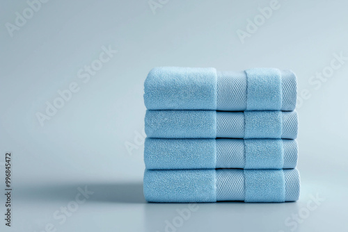 Stack of blue towels on a white background, premium textiles, bathroom essentials, professional setup, textile concept