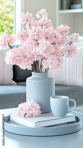 Wallpaper Mural This inviting living room features a soft color palette with a coffee cup, stacked books, and fresh flowers on the sofa, creating a perfect spot for relaxation and comfort Torontodigital.ca