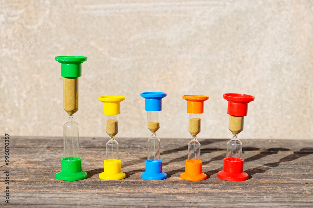 Hourglasses on rustic wooden table Hourglasses on rustic wooden table