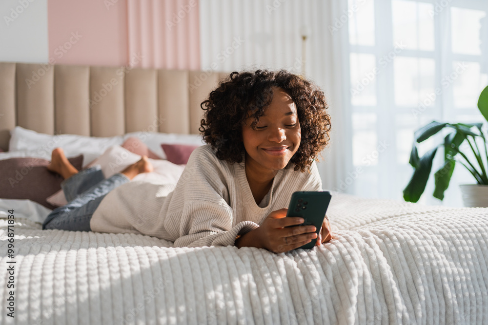 African girl holding smartphone touch screen typing scroll page at home. Woman with cell phone surfing internet using social media apps playing game. Shopping online Internet news cellphone addiction African girl holding smartphone touch screen typing scroll page at home. Woman with cell phone surfing internet using social media apps playing game. Shopping online Internet news cellphone addiction