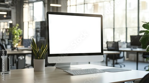 An empty office desk with a computer screen displaying a blank page, providing space for copy.