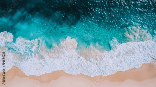 Waves crashing on a sandy beach under bright daylight near a tranquil ocean shoreline