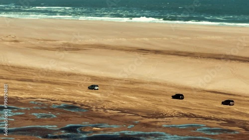 An aerial view of a car driving in Sandwich Harbour, Walvis Bay, Namibia.