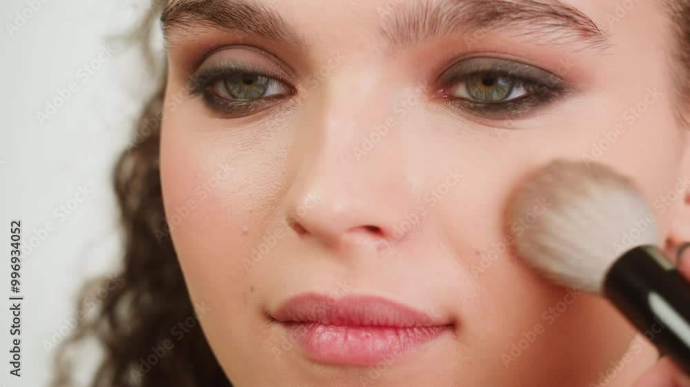 Beauty shot of woman makeup artist applying foundation bb cream on previously applied moisturizing young woman face close-up. Concept of skincare, cosmetics, make up, beauty Beauty shot of woman makeup artist applying foundation bb cream on previously applied moisturizing young woman face close-up. Concept of skincare, cosmetics, make up, beauty