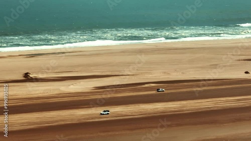 An aerial view of a car driving in Sandwich Harbour, Walvis Bay, Namibia.