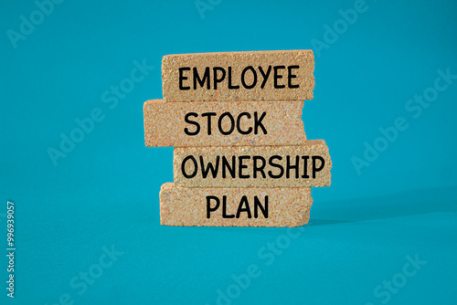 Obraz na płótnie Concept words ESOP - Employee Stock Ownership Plan on brick blocks. Beautiful blue background. Business concept. w salonie