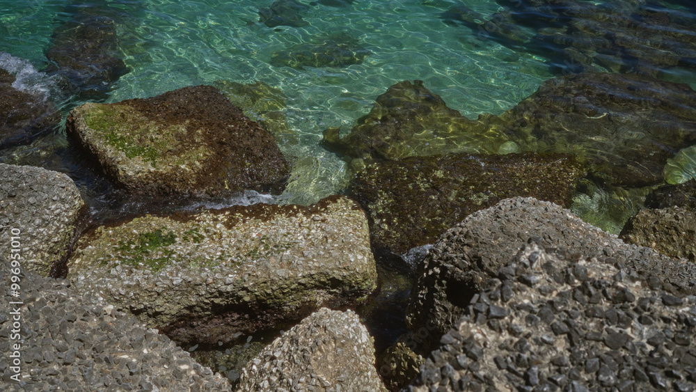 Rocky coastline with clear turquoise water in gallipoli, puglia, italy, showcasing picturesque nature and ocean scenery. Rocky coastline with clear turquoise water in gallipoli, puglia, italy, showcasing picturesque nature and ocean scenery.