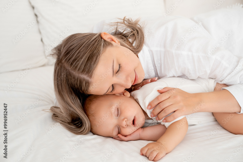 mom puts the baby to sleep hugging and kissing him before going to bed, healthy sleep together with the mother mom puts the baby to sleep hugging and kissing him before going to bed, healthy sleep together with the mother