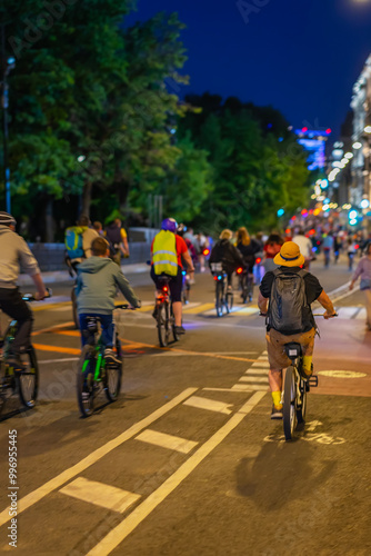 Wallpaper Mural Cyclists riding through a vibrant city street at night during community biking event in summer Torontodigital.ca