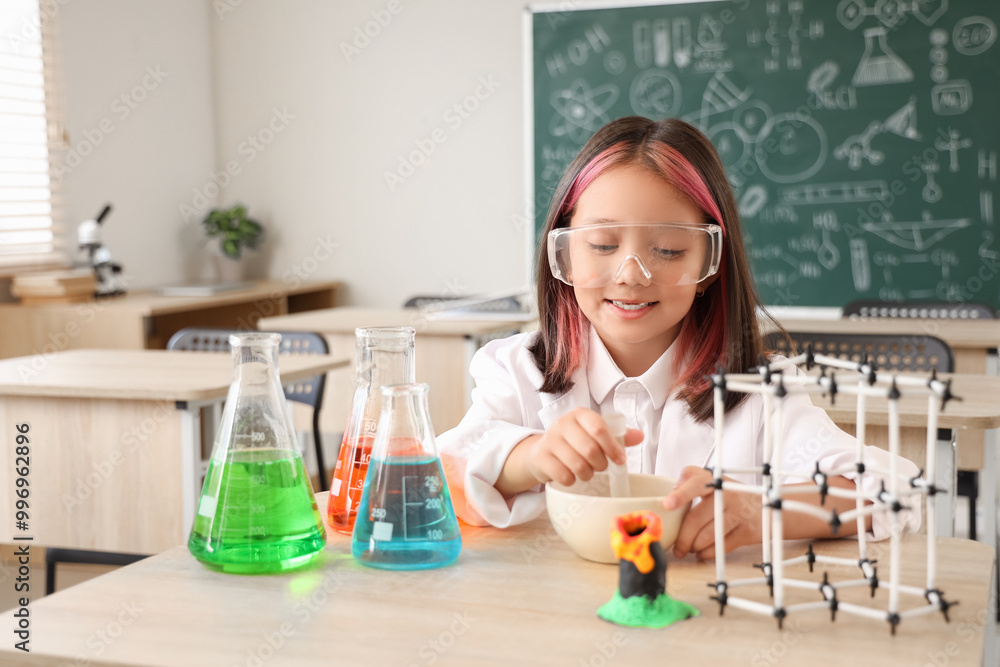 Cute little girl studying chemistry in science classroom Cute little girl studying chemistry in science classroom