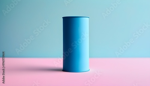 Blue cylinder on pink surface with soft blue and pastel backdrop