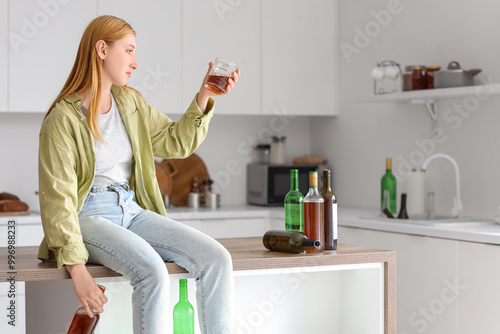 Young woman drinking alcoho...
