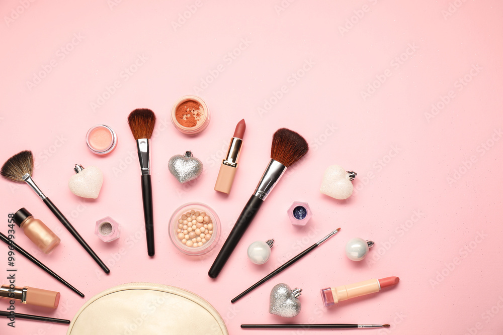 Cosmetic bag, makeup brushes, decorative cosmetics and Christmas decor on pink background, flat lay Cosmetic bag, makeup brushes, decorative cosmetics and Christmas decor on pink background, flat lay
