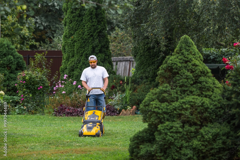 The banner. A lawn mower man mows the grass in the backyard. Agricultural machinery for garden maintenance.