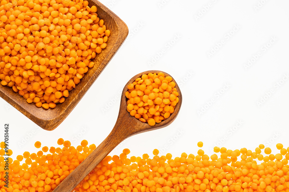 Lens culinaris - Raw red lentils in a bowl and spoon. Lens culinaris - Raw red lentils in a bowl and spoon.