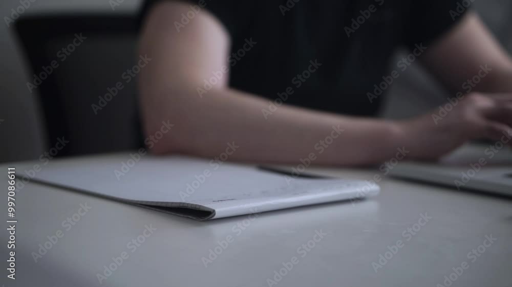 Man Writing Ideas While Working on Laptop Man Writing Ideas While Working on Laptop