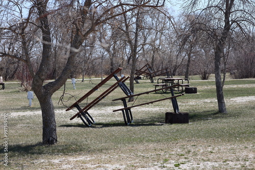 array of picnic tables stacked for winter storage photo