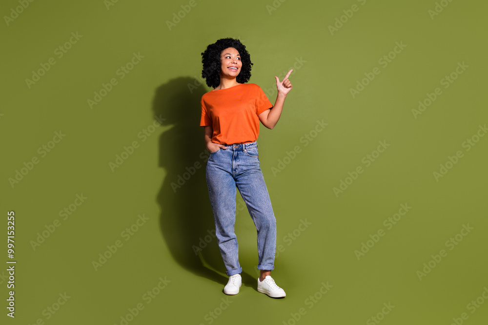 Full size photo of pretty young girl point look empty space wear trendy orange outfit isolated on khaki color background Full size photo of pretty young girl point look empty space wear trendy orange outfit isolated on khaki color background