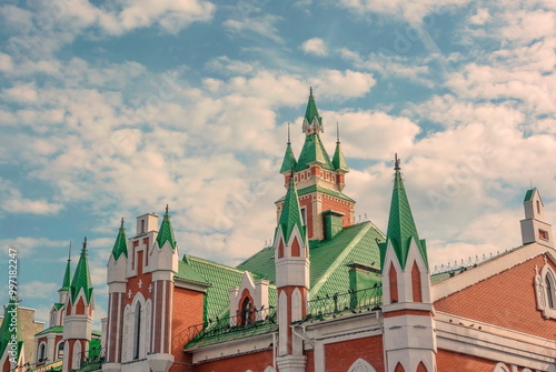 A modern stylized building with a tiled roof and ornate towers