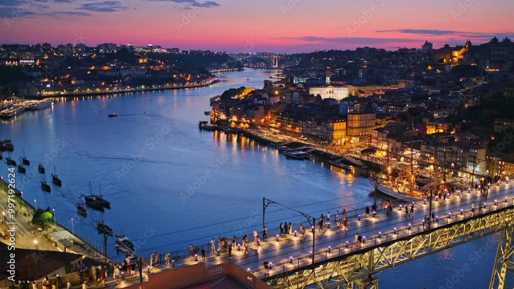 View of illuminated Porto city and Douro river and Dom Luis bridge I from famous tourist viewpoint Miradouro da Serra do Pilar in evening twilight. Porto, Vila Nova de Gaia, Portugal. Camera pan View of illuminated Porto city and Douro river and Dom Luis bridge I from famous tourist viewpoint Miradouro da Serra do Pilar in evening twilight. Porto, Vila Nova de Gaia, Portugal. Camera pan