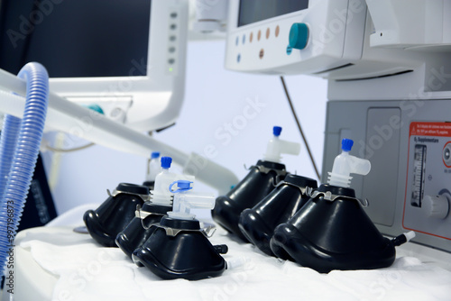 Various black oxygen/anesthesia masks in an operating room