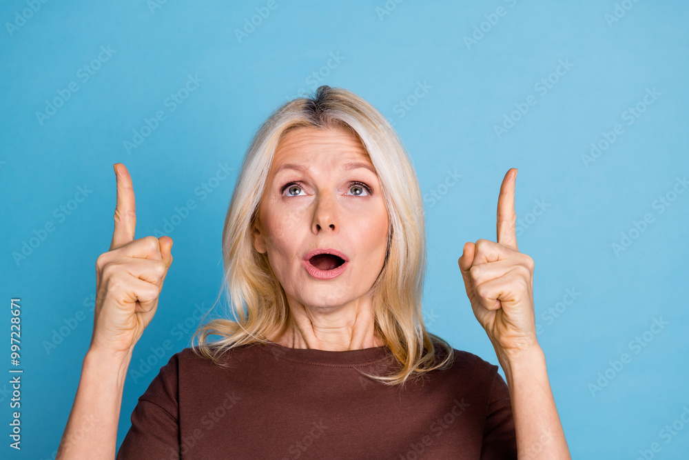 Photo of adorable gorgeous woman wear brown stylish clothes look empty space isolated on blue color background Photo of adorable gorgeous woman wear brown stylish clothes look empty space isolated on blue color background