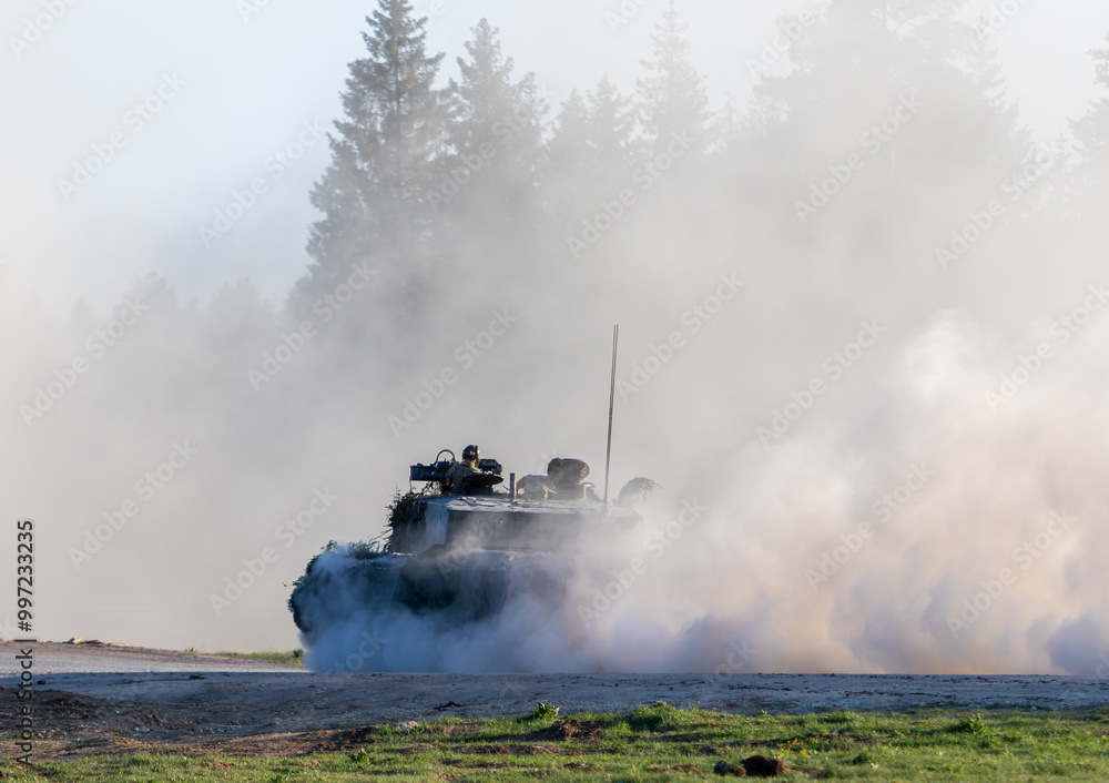 Challenger 2 tank or FV4034 driving down a dirt road on a training area Challenger 2 tank or FV4034 driving down a dirt road on a training area