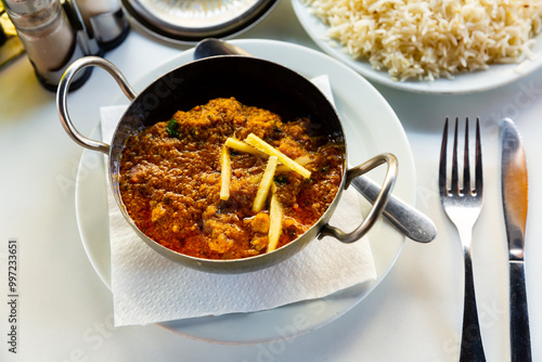 Traditional Indian lamb karahi curry served with ginger and white rice. National cuisine dish photo