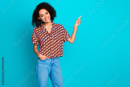 Photo of girlish lovely lady dressed print shirt pointing finger empty space isolated teal color background