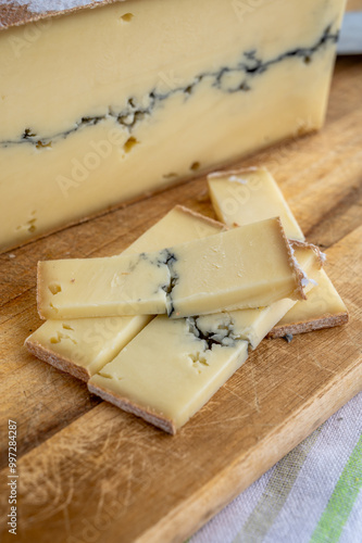 Cheese collection, French Morbier semi-soft cow milk cheese with black mold layer close up photo