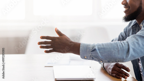 Deal. Closeup of african american businessman giving hand for handshake, proposing partnership, copy space photo