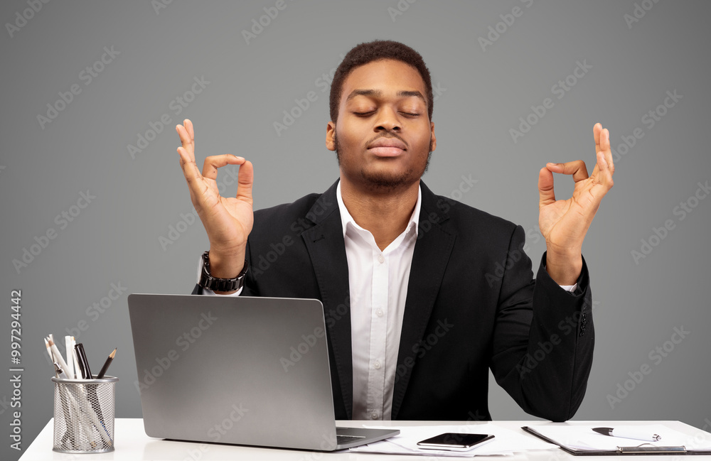 Relaxation At Work. Afro businessman meditating at work, dealing with stress and anxiety. Free space Relaxation At Work. Afro businessman meditating at work, dealing with stress and anxiety. Free space