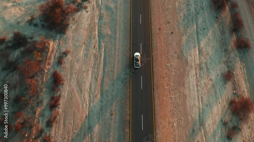 White pick up four by four carrying equipment, driving on the sand of the Namib desert .