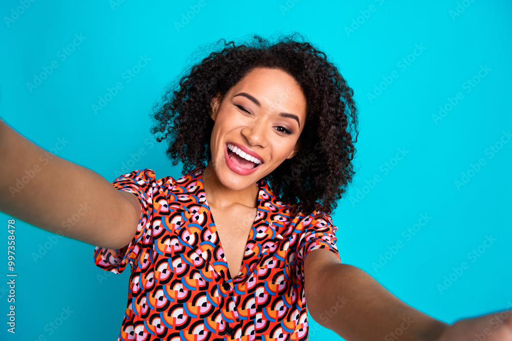 Photo of flirty attractive lady dressed print shirt tacking selfie winking eye isolated turquoise color background Photo of flirty attractive lady dressed print shirt tacking selfie winking eye isolated turquoise color background