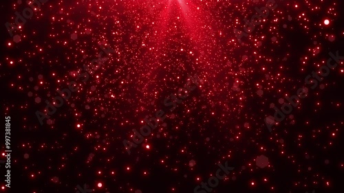 Falling red glitter particles background of red light.
