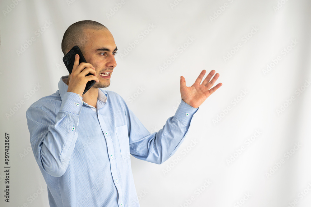 Young office worker arguing over his smart phone. Businessman talking on his phone. Young office worker arguing over his smart phone. Businessman talking on his phone.