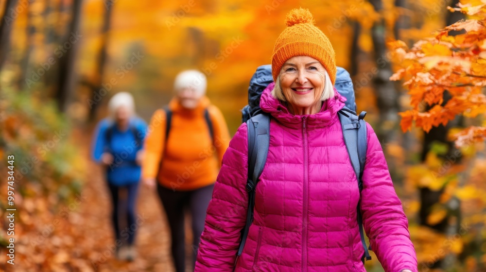 Elderly woman hiking in an autumn forest with a bright orange hat and pink jacket, smiling and enjoying the vibrant fall scenery Elderly woman hiking in an autumn forest with a bright orange hat and pink jacket, smiling and enjoying the vibrant fall scenery