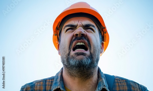 Construction worker or builder, looking angry and upset, like an architect or engineer, with a problem, stressed photo