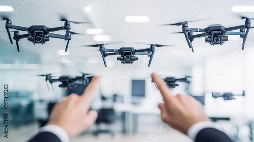 People controlling drones in a modern office environment with computers