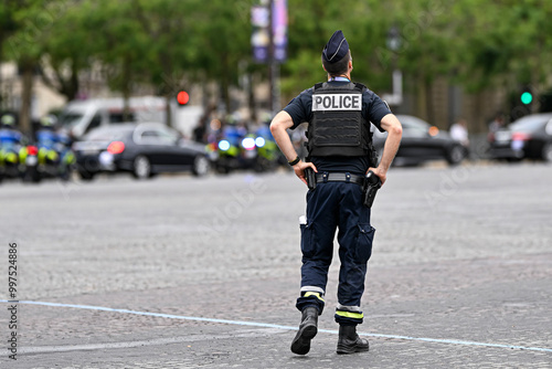 Fototapeta Naklejka Na Ścianę i Meble -  Illustration picture showing a male police officer (man) with uniform ensuring security in Paris, France on September 26, 2024. French national policeman in action.
