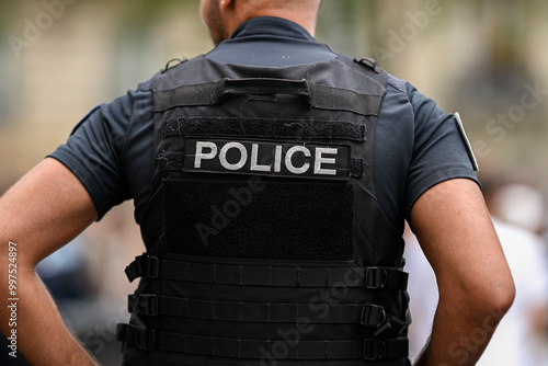 Fototapeta Naklejka Na Ścianę i Meble -  Illustration picture showing a male police officer (man) with uniform ensuring security in Paris, France on September 26, 2024. French national policeman in action.