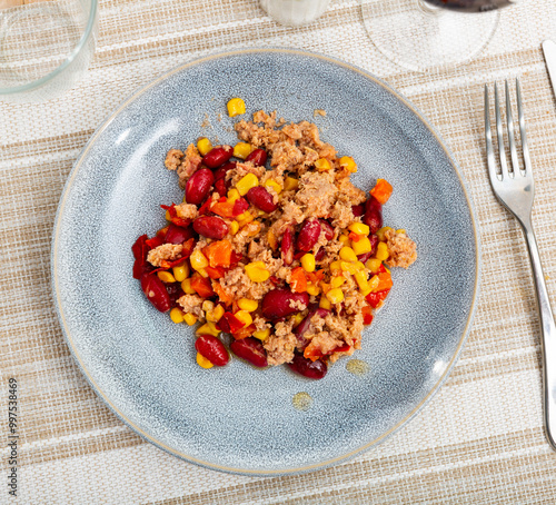 Plate of light and nutritious salad made with tender crushed tuna, kidney beans, sweet corn, and fresh vegetables served in simple style. Mexican cuisine.. photo