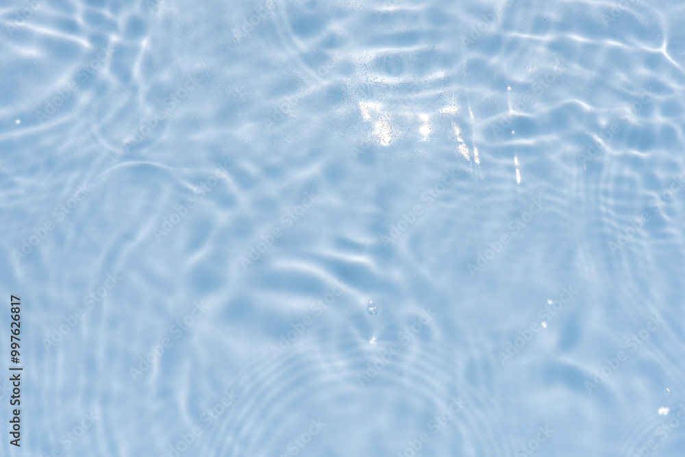 Blue water with ripples on the surface. Defocus blurred transparent blue colored clear calm water surface texture with splashes and bubbles. Water waves with shining pattern texture background. Blue water with ripples on the surface. Defocus blurred transparent blue colored clear calm water surface texture with splashes and bubbles. Water waves with shining pattern texture background.