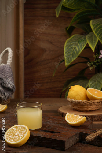 lemon juice and lemon slices with a darkmood photo concept on a brown wooden background photo