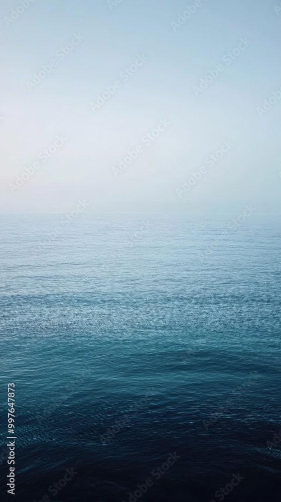 A serene view of calm ocean water under a soft blue sky, creating a peaceful and tranquil atmosphere for relaxation. A serene view of calm ocean water under a soft blue sky, creating a peaceful and tranquil atmosphere for relaxation.